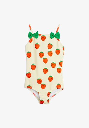 Cream-colored child's swimsuit with orange strawberry pattern, green leaf details, and two green bows on the shoulder straps.