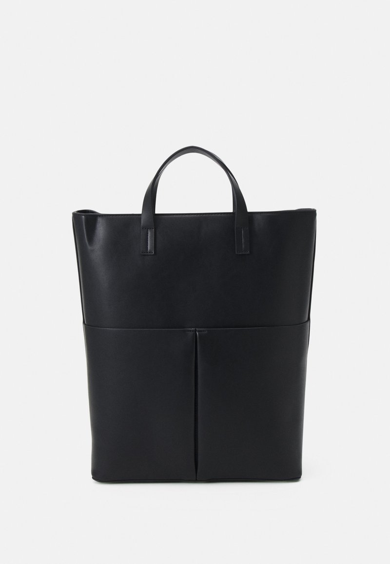 Black leather tote bag featuring two top handles, a structured rectangular shape, and a front pocket with vertical seam detailing.