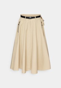 Beige A-vonalú szoknya, könnyű anyagból, redőzött, fekete övvel, négyzet alakú csattal és oldalsó cipzáras zsebekkel.