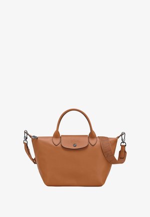 Tan leather handbag with a rounded shape, dual top handles, and a detachable strap. Features a front snap closure and subtle logo detail.