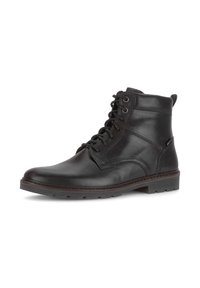 Zwarte leren enkelboots met een ronde neus, vetersluiting, gestikte details en een getextureerde rubberen zool voor grip.