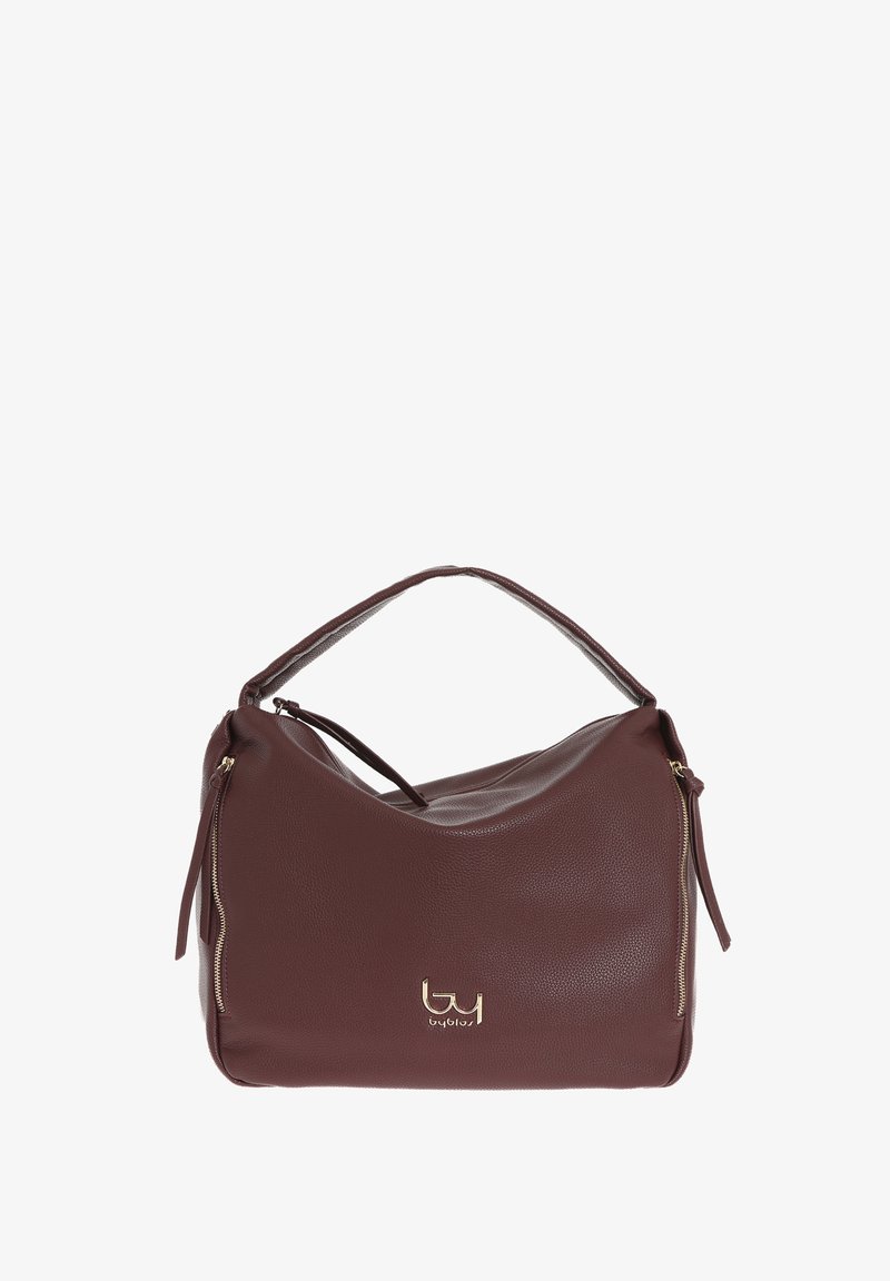 Sac à main en cuir marron avec une forme douce et arrondie. Equipé d'une bandoulière courte, de quincaillerie dorée et d'une poche zip sur le côté.