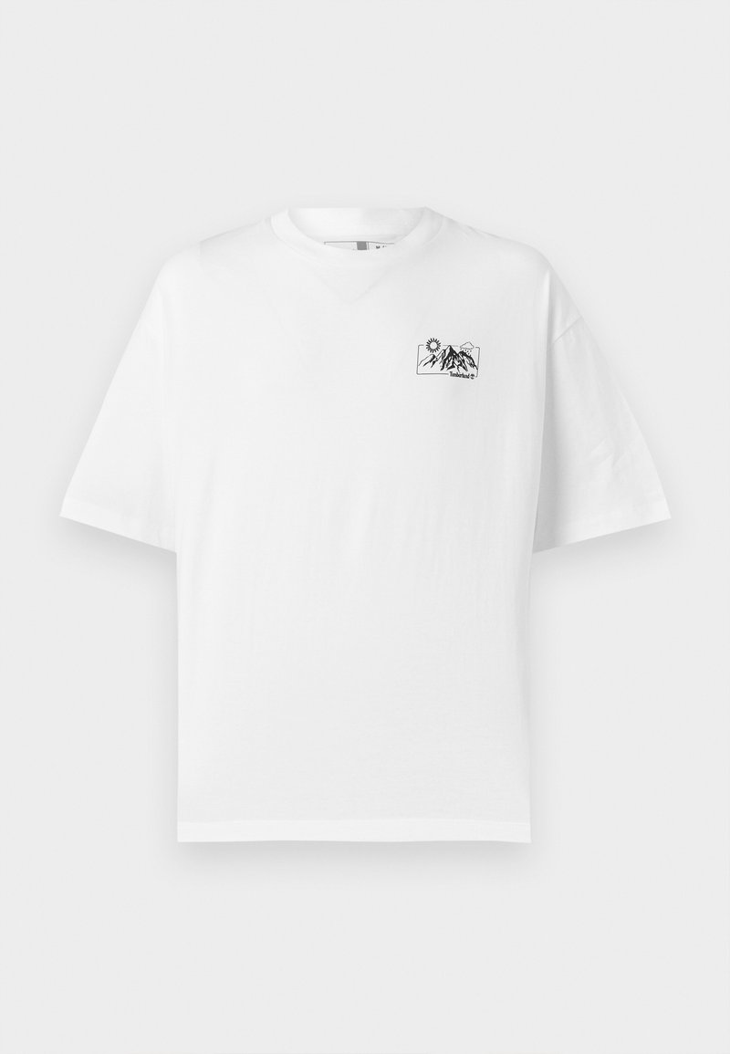 T-shirt en coton blanc à coupe décontractée, avec un petit graphique noir de montagne et un design de soleil sur le côté gauche de la poitrine.