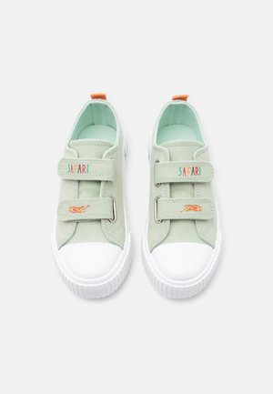 Pair of light green children's sneakers with white rubber toes, Velcro straps labeled "SAFARI," and small tiger illustrations on the straps.