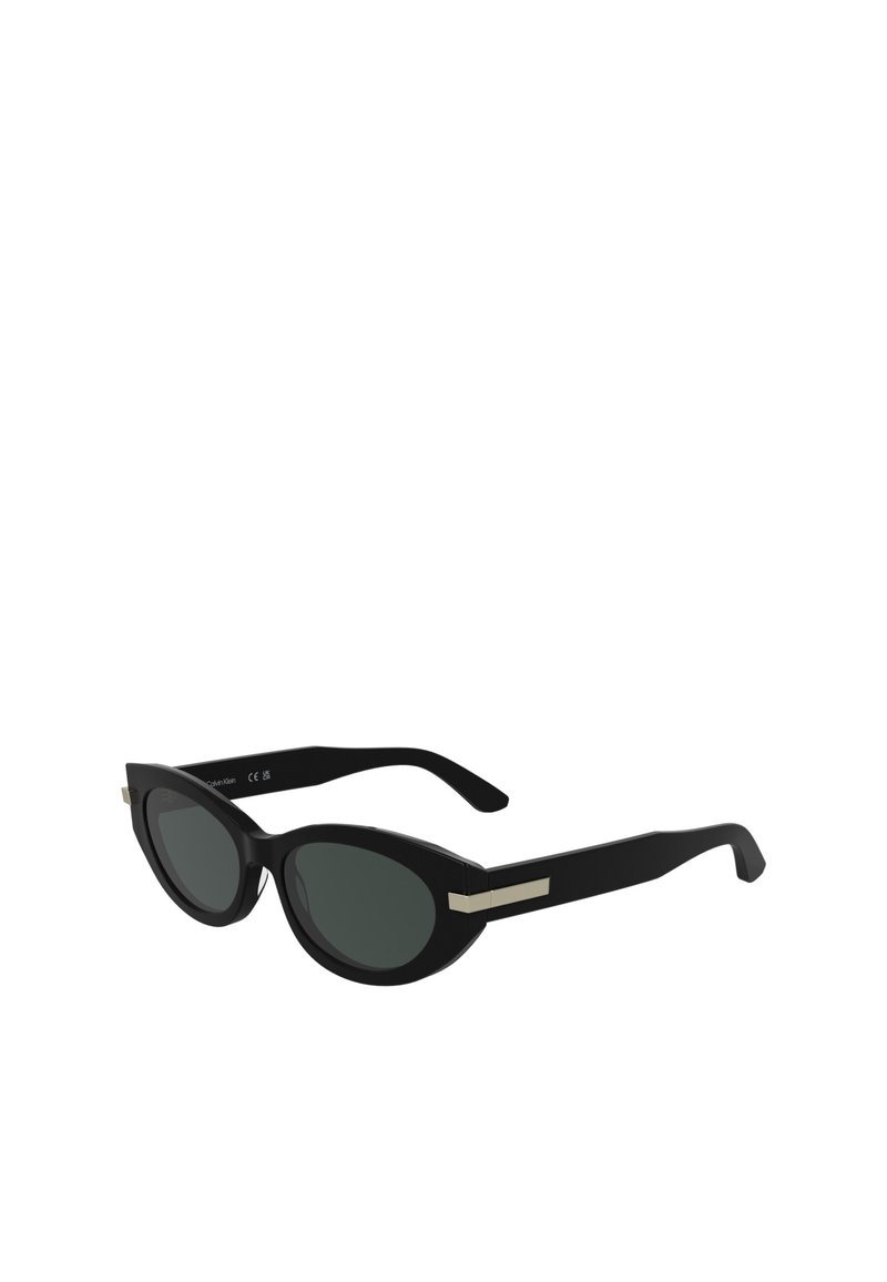 Black sunglasses with dark lenses, oval shape, and glossy plastic frame. Features gold-tone accents on the temples.