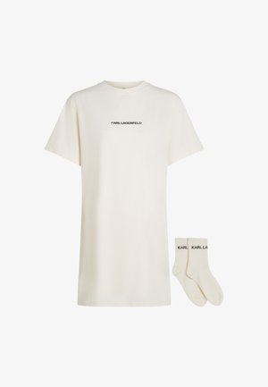 Cream short-sleeve T-shirt made of cotton, featuring a black "KARL LAGERFELD" logo across the chest. Accompanied by matching cream socks.