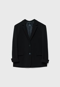 Veste noire cintrée avec revers crantés, deux boutons sur le devant, poches à rabat et poignets retroussés, présentée sur un fond clair uni.