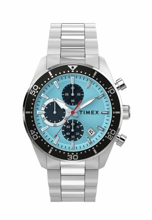 Stainless steel Timex wristwatch with blue dial, three black subdials, red second hand, date window at four o'clock, and black bezel with minute markers.