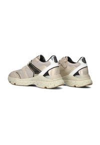 Sport shoes featuring a mix of beige mesh and leather, with black accents, white heel cap, and a textured sole in a contrasting color.