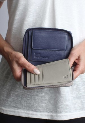 Leather wallet in navy and gray, featuring a zip closure, card slots, and embossed text. Smooth texture with a compact rectangular shape.