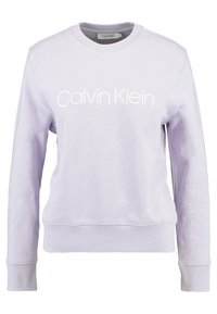 Sudadera de algodón morada con mangas largas y cuello redondo. Presenta un logo blanco de "Calvin Klein" en el pecho y puños acanalados.