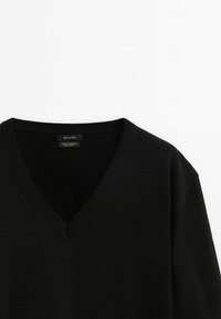 Black cashmere wool sweater with a V-neck design. Features ribbed collar and cuffs, soft texture, and minimalistic style.