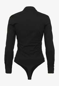 Body noir ajusté à manches longues avec col et poignets boutonnés, vu de dos sur un fond blanc uni.