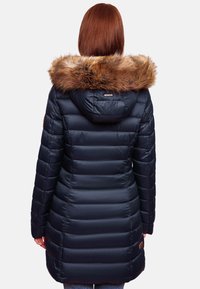 Navy puffer coat featuring a faux fur hood, horizontal quilted design, and a slightly longer back. Includes a small brand tag on the side.