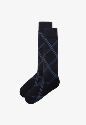 Calzini neri con un motivo a rombi in filato blu. Realizzati in un tessuto morbido con una texture liscia, progettati con un polsino a coste.