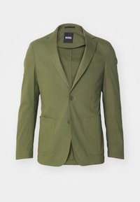 Blazer verde realizzato in tessuto texturizzato, con due tasche frontali, chiusura a un bottone e revers a punta. Etichetta del marchio visibile all'interno.