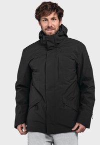 Schwarze wasserdichte Jacke mit hohem Kragen, Reißverschlusstaschen und verstellbaren Bündchen. Sie zeichnet sich durch ein elegantes Design und strapazierfähiges Material aus.