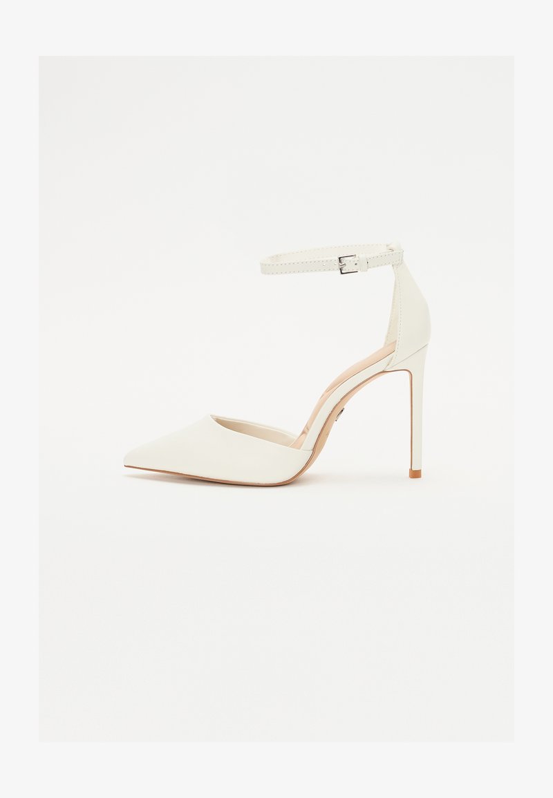 White leather high-heeled shoe with a pointed toe and thin ankle strap. Features a stiletto heel and minimalistic design.
