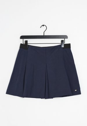 Navy blue pleated skirt with black waistband hanging on a black hanger against a white background.