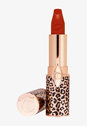 Lippenstift in einem Gehäuse mit Leopardenmuster, metallischen Roségoldakzenten und einem orange-roten Bullet mit einem Lippenabdruck an der Spitze.