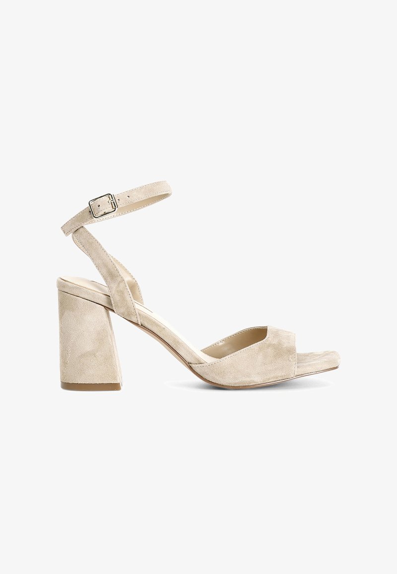 Beige suede block-heel sandal with a peep-toe design, ankle strap with buckle, and smooth texture on upper and sole.