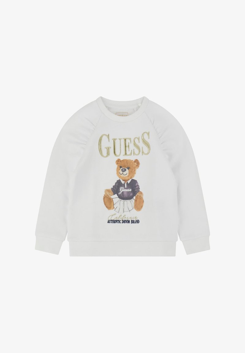 White sweatshirt featuring a cartoon bear in a black shirt and white skirt, with "GUESS" text above and "AUTHENTIC DENIM BRAND" below.