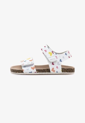 Sandalia blanca para niños con suela de corcho y patrones de corazones multicolores, con dos tiras ajustables de velcro para un ajuste seguro.