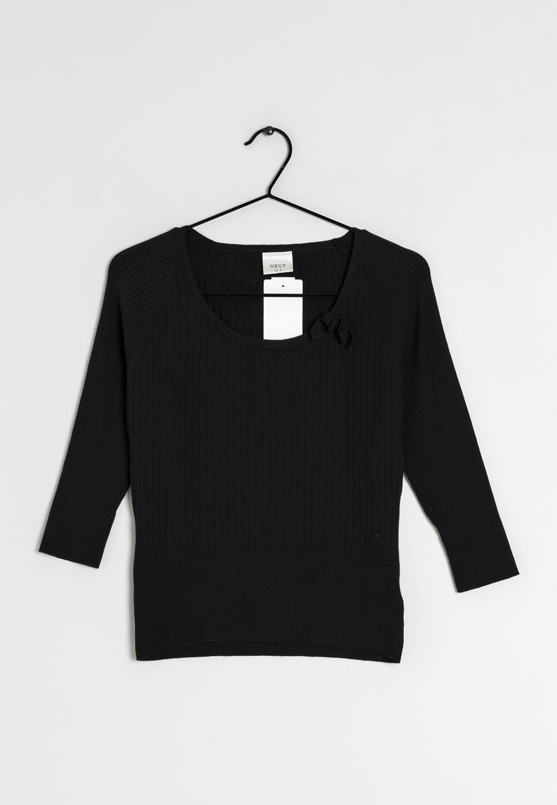 Top noir à manches longues côtelé avec un décolleté en forme de scoop, doté d'un accent nœud à l'avant. Le tissu est texturé avec une silhouette ajustée.