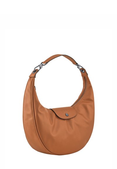 Medium-sized orange leather crescent handbag with a short strap, zipper on the side, and front flap pocket with button closure.