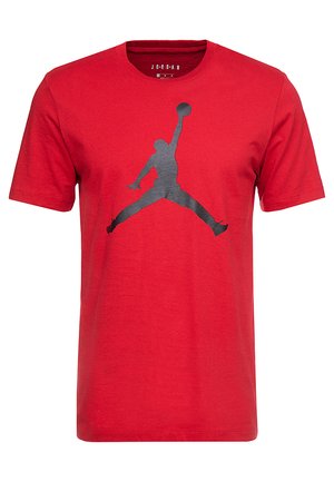 T-shirt en coton rouge avec un graphique en silhouette noire "Jumpman", design à col rond et manches courtes, avec une texture douce.