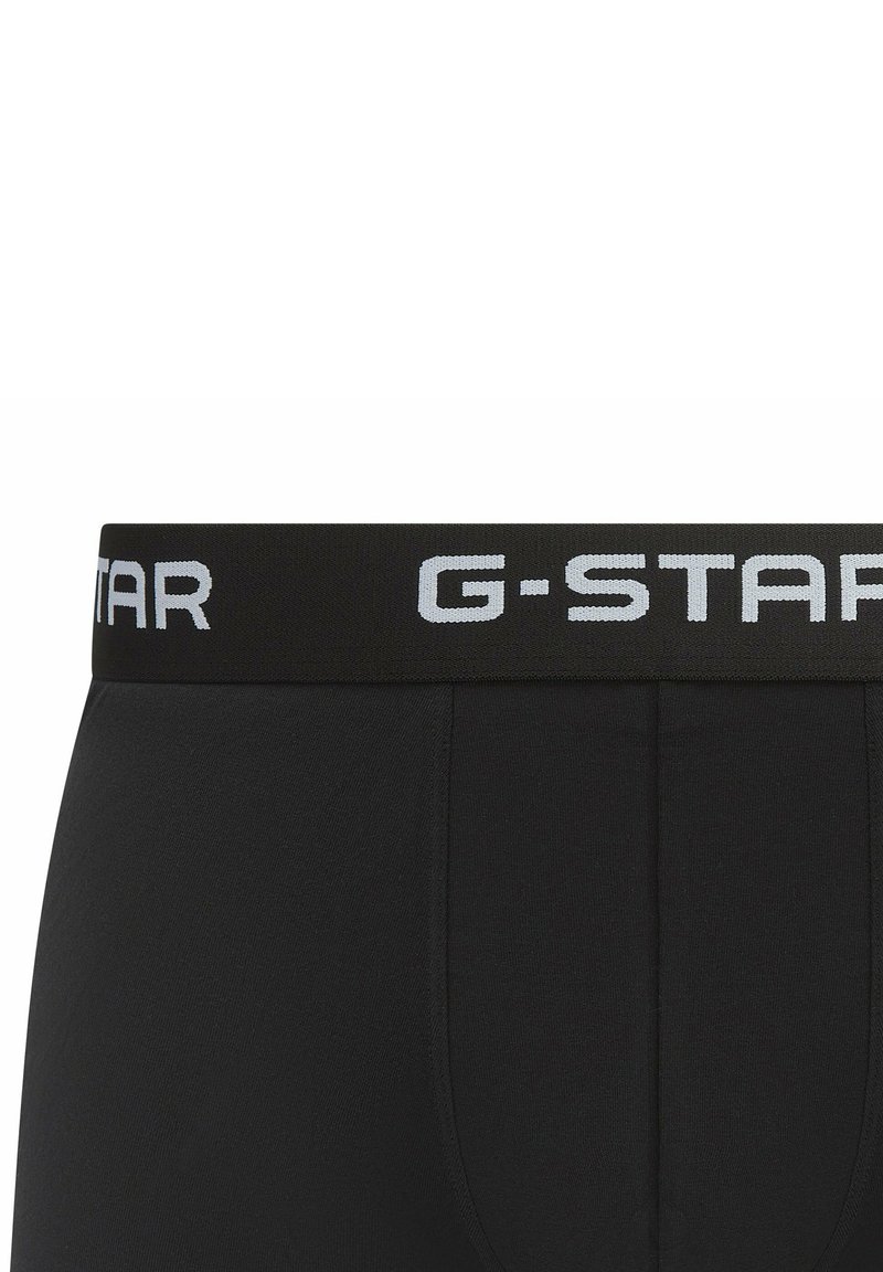 Boxers en coton noirs avec une ceinture texturée portant le logo G-Star en gris clair contrasté. Tissu doux et design ajusté.