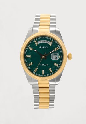 Hodinky na zápästie Versace so zeleným ciferníkom, zlatým a strieborným kovovým remienkom, zobrazením dňa a dátumu, zlatým rámom a automatickým strojčekom.