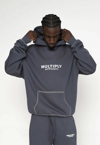 Szary polarowy hoodie z kieszenią kangurką, biały tekst marki "MULTIPLY APPAREL" z przodu oraz kontrastowe detale szycia.