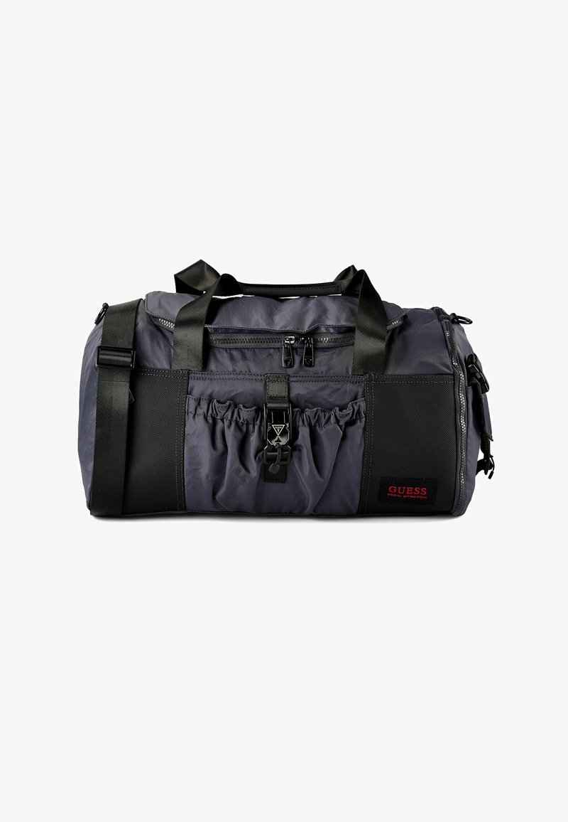 Donkergrijze duffeltas met zwarte accenten, nylon materiaal, twee handgrepen aan de bovenkant, verstelbare schouderriem, voorvak met rits en elastisch zijvak.