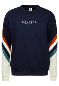 Marineblå sweatshirt lavet af bomuld, med multicolore stribede detaljer og runder hals. Logoet "KAOTIKO" og "SINCE 1999" broderet på forsiden.