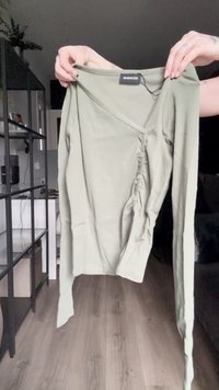 Olive green long-sleeve cardigan with a V-neck, ribbed texture, seven button closures down the front, and long, tapered sleeves.