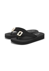 Black flip-flops with thick rubber sole, textured straps, and decorative buckles. Minimalist design with modern accents and a comfortable fit.
