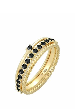 Bague en or avec un anneau torsadé et une rangée de pierres précieuses noires serties dans des griffes en or, marquée "925" à l'intérieur.