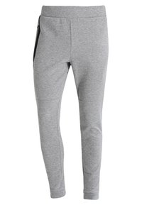Graue Jogginghosen aus Baumwollgemisch mit taillierter Passform, elastischem Bund und seitlichen Reißverschlusstaschen. Glatte Textur mit minimaler Nahtführung.