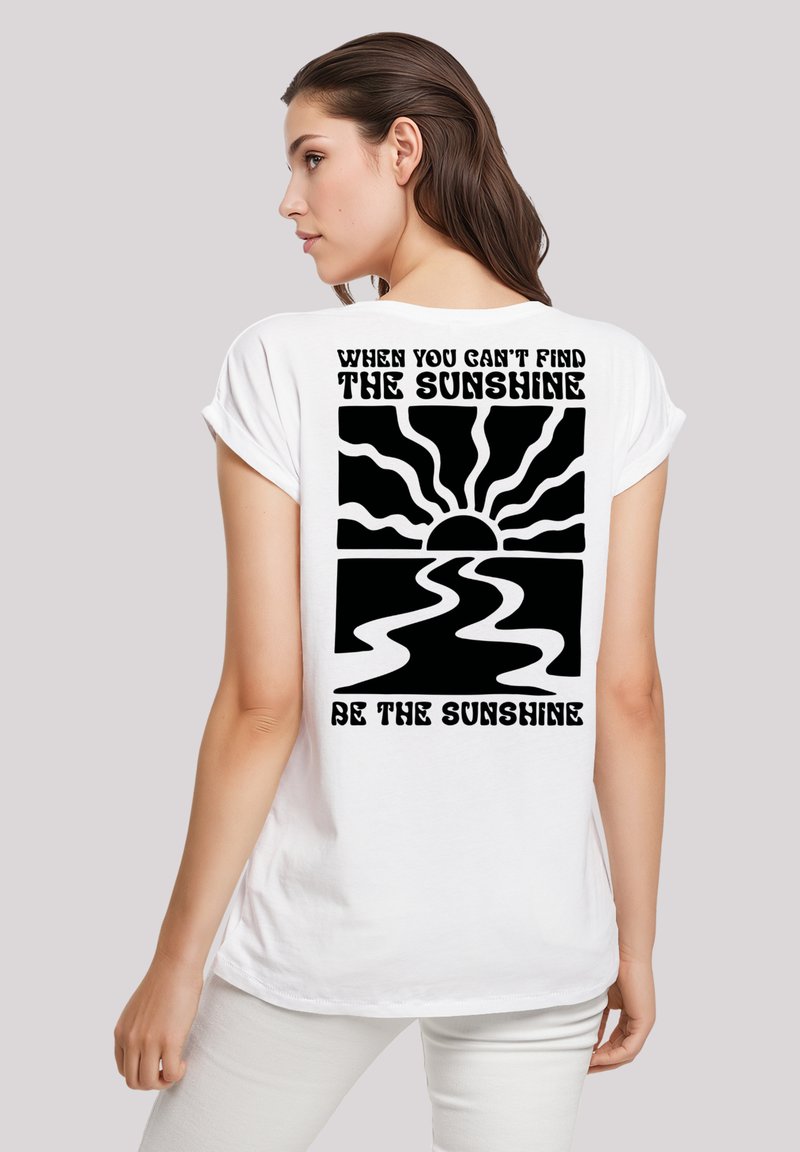 White cotton t-shirt with short sleeves, featuring a black graphic design on the back with a sun and text "When you can't find the sunshine, be the sunshine."