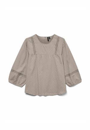 Svetlo bež bluzka z okroglim izrezom, napihnjenimi rokavi in kontrastnimi vezenimi detajli na telesu in manšetah. Teksturovan material z majhnimi vzorci.