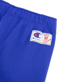 Paarse katoenen sweatpants met een elastische tailleband. Bevat een Champion-logolabel met rode en blauwe accenten. Zachte textuur met een gladde afwerking.
