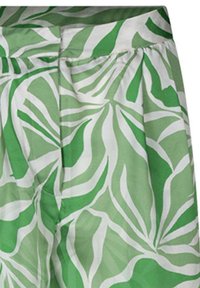 Jupe verte et blanche à motif de feuilles tropicales, fabriquée en tissu léger, dotée d'une taille plissée et de poches dissimulées.