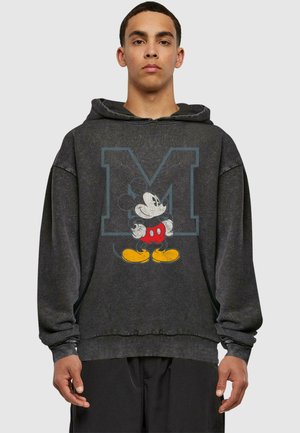 Black hoodie with a distressed finish, featuring a graphic of Mickey Mouse in red shorts and yellow shoes, and an oversized "M" logo.