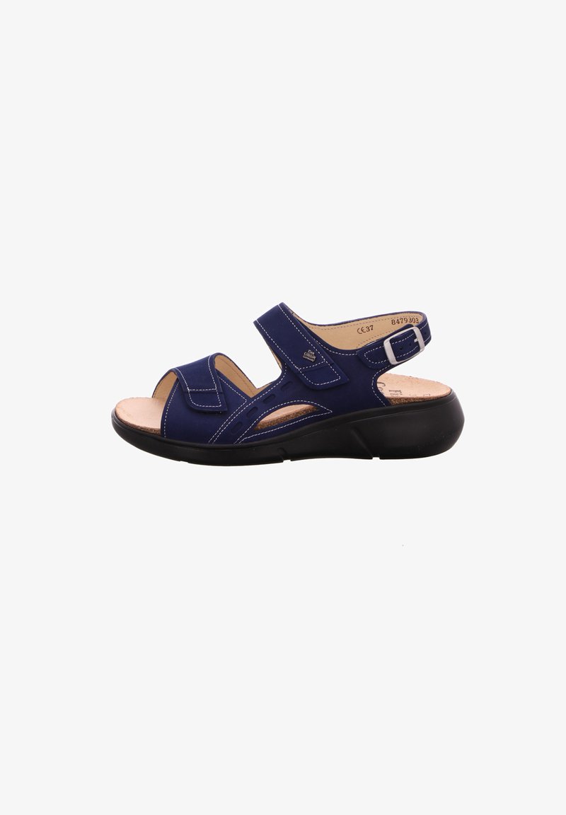 Blue sandal made of synthetic material, featuring a cushioned interior, velcro straps, and a sturdy black sole with cut-out details.