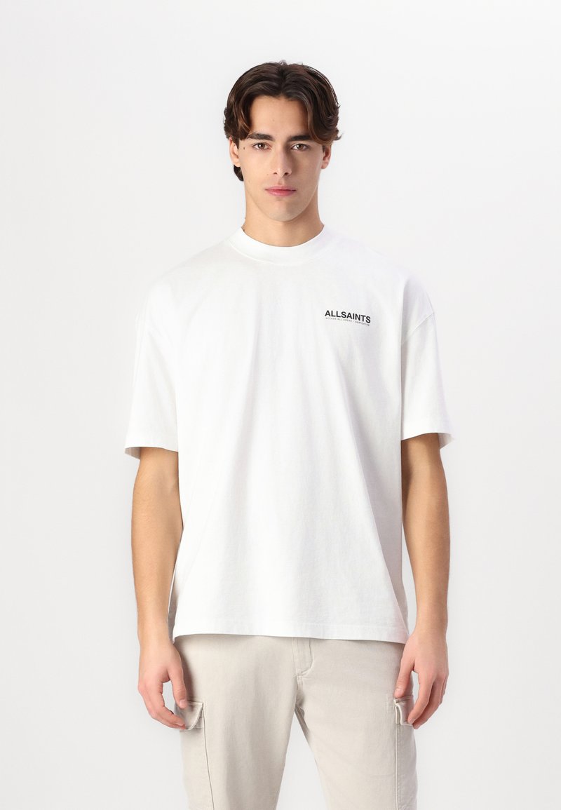 White cotton t-shirt with short sleeves and a crew neck. Features black "ALLSAINTS" text logo on the left chest. Simple design and relaxed fit.