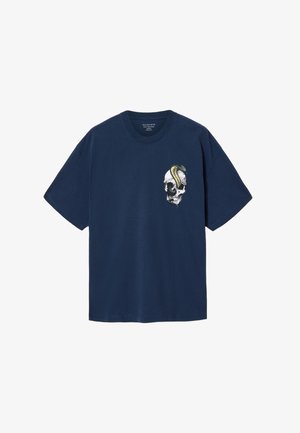 Navy blue cotton t-shirt featuring a skull graphic with a coiled snake. Short sleeves and a crew neckline. Relaxed fit, smooth texture.