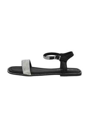 Black sandal with a flat sole, featuring a rhinestone-embellished strap, adjustable ankle strap, and smooth leather upper.