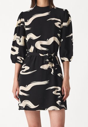 Sort kjole med beige abstrakt swirl-mønster, trekvart puffede ærmer, høj halsudskæring og matchende stofbælte bundet i taljen.