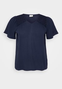 Navy blue short-sleeve blouse with a V-neckline, featuring textured fabric panels on the shoulders and a smooth, flowing body.